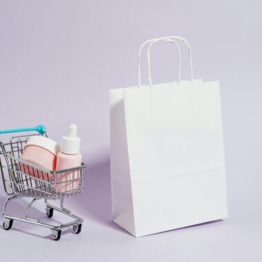 A minimalist image featuring a shopping cart with cosmetics and a white paper bag, ideal for Black Friday promotions.